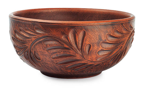 Beautiful old clay bowl with floral patterns isolated on white