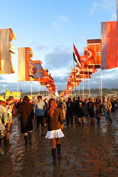 Glastonbury festival music festival flags mud crowds stock photo