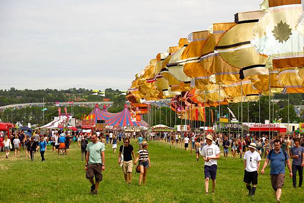 Glastonbury festival music festival sunny day crowds music tents stock photo