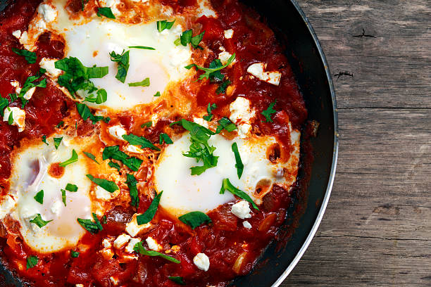 Fresh Eggs poached, tomato sauce and red, yellow pepper, onion