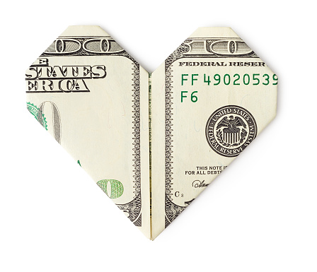 One hundred dollars folded into heart isolated on white background. Love money concept.