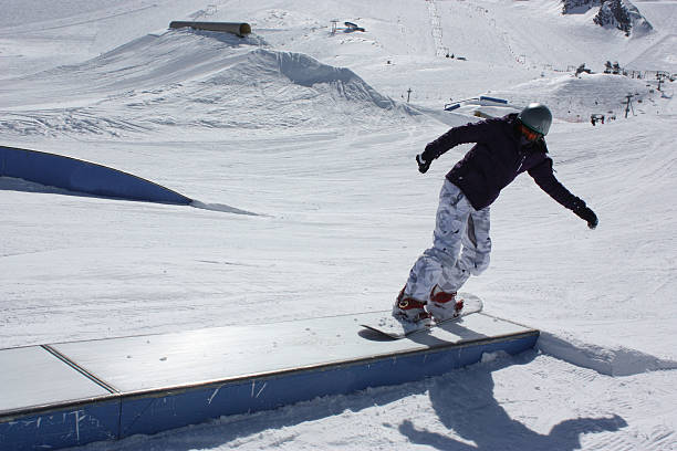 istock Young snowboarder woman sliding on a box. 515007276