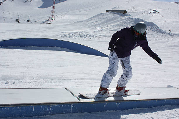 istock Young snowboarder woman sliding on a box. 515007306