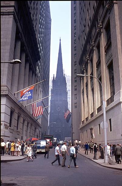 Wall Street, 1969 
New York City, NYS, USA May 15, 1969. The Wall Street in Manhattan between Nassau St, and Broadway on a normal working day in May 1969. In the background you can see the Trinity Church. dealing room photos stock pictures, royalty-free photos & images