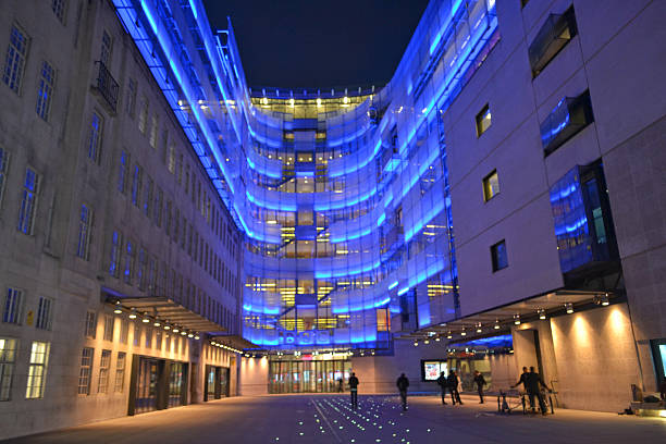 BBC night time London, UK - September 13, 2014: night view of BBC Broadcasting House in London, UK with people standing in front. The building is the headquarters of the BBC and was opened in 1932. bbc photos stock pictures, royalty-free photos & images