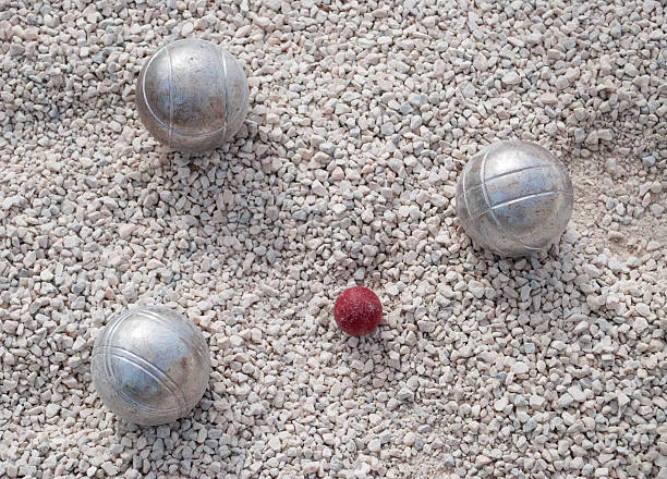 Senior Woman Marking Where Bocce Ball Has Stopped.
