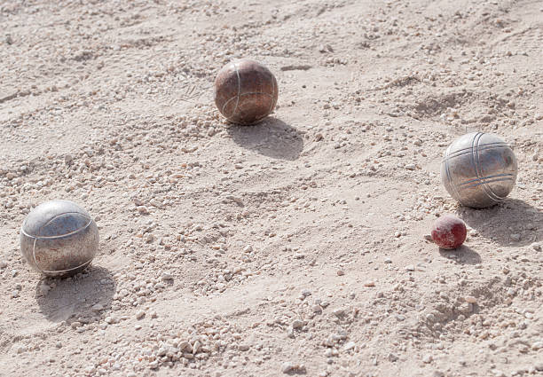 istock Metallic petanque balls and a small red jack 515008875