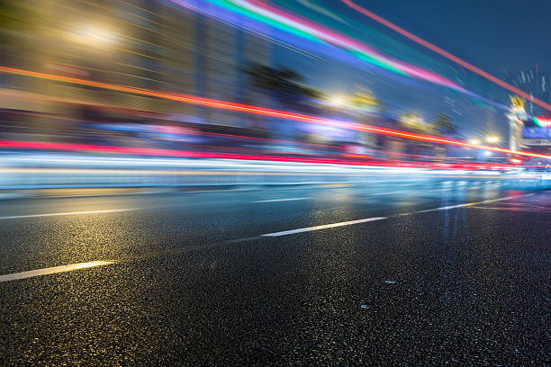 trafic de nuit sur la ville - defocused blurred motion road street photos et images de collection