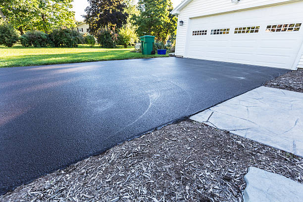 New Blacktop Asphalt Driveway A fresh blacktop resealing job just finished on this asphalt driveway in a suburban residential district. tarmac stock pictures, royalty-free photos & images