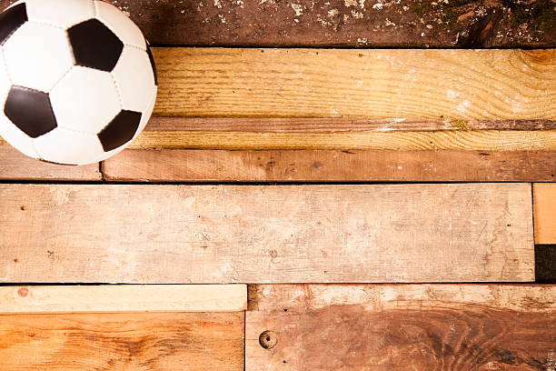 istock Sports Background: Soccer ball on unique wooden boards background. 515011149
