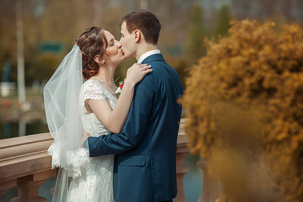 istock Newlyweds are kissing in a park 515012000