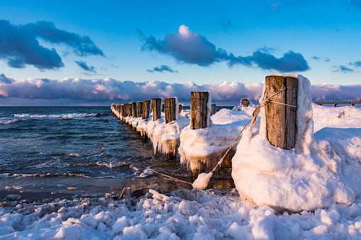Groyne on shore of the Baltic Sea in winter.