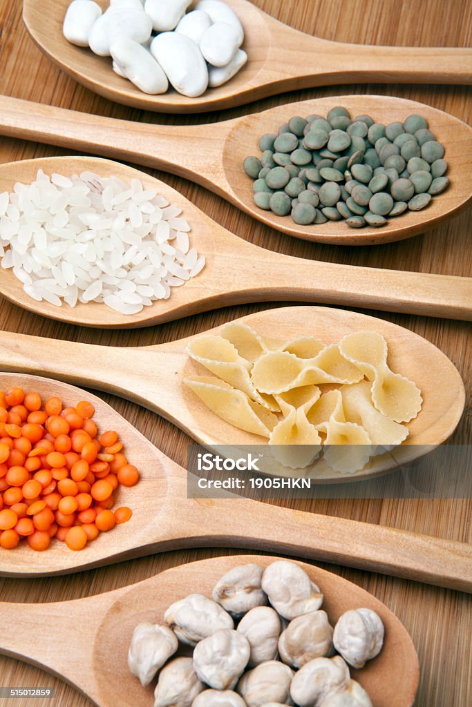 Pulses and spoons Spoons with different kinds of pulses Bean Stock Photo