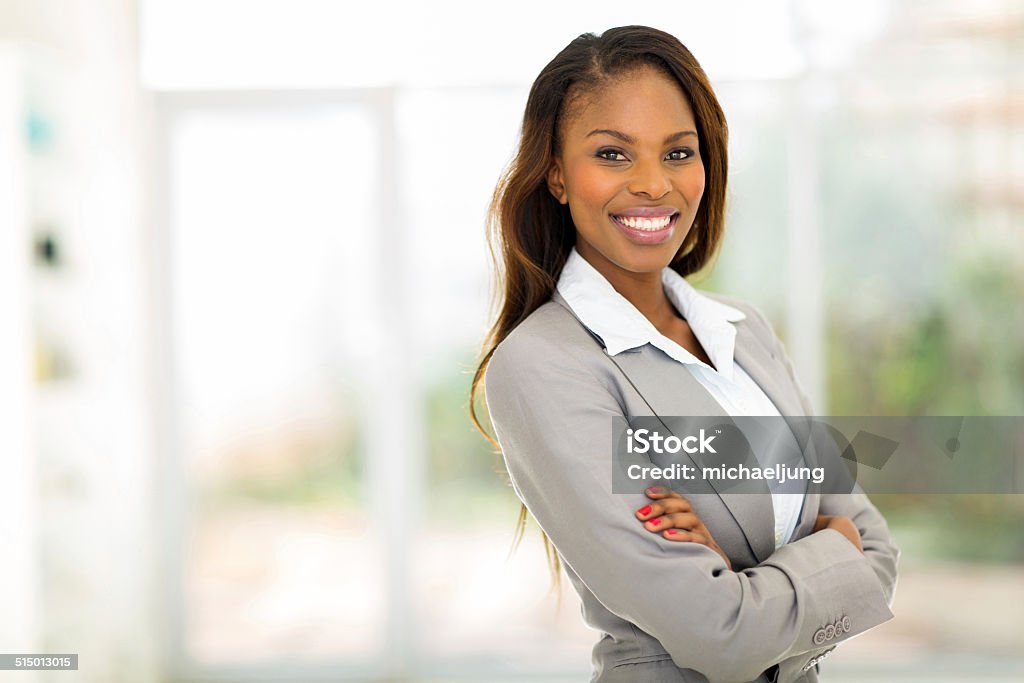 young african american businesswoman in office portrait of young pretty african american businesswoman in office Professional Occupation Stock Photo