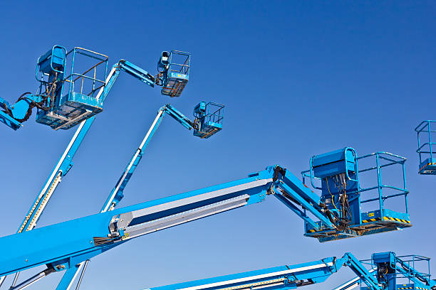 Hydraulic lifts against blue sky Hydraulic lifts against blue sky mobile crane stock pictures, royalty-free photos & images
