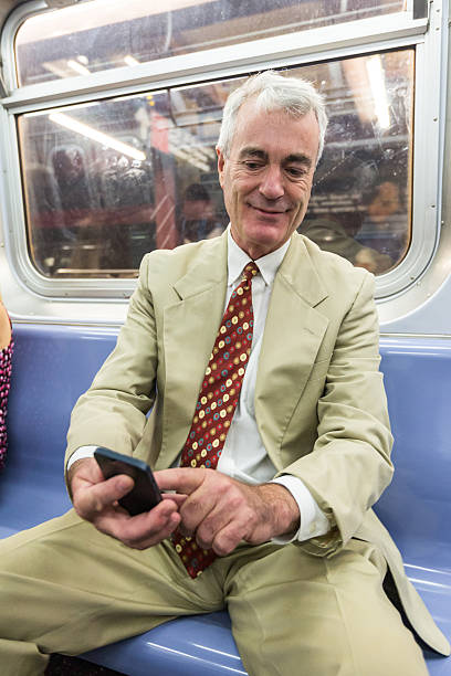 istock Senior Businessman Using Mobile Phone in the Subway Train 515013815