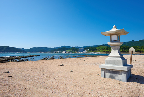 A Granite lantern on the beach of Aoshima town. Miyazaki Prefecture. Japan.