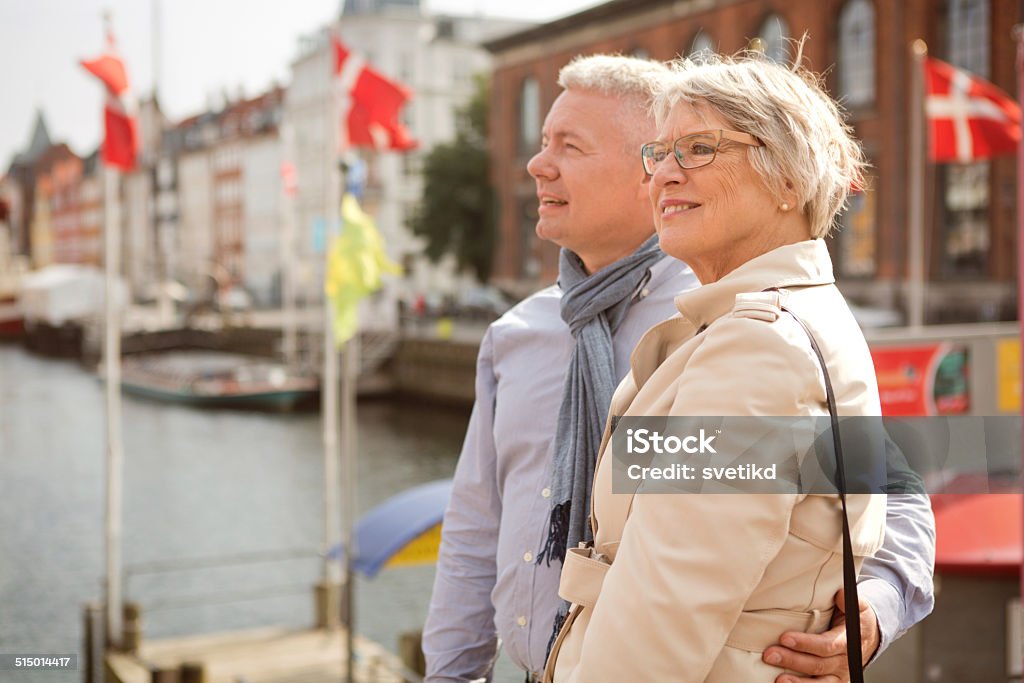 Mature couple in a city. Cheerful mature couple looking at landmark. Nyhavn, Denmark, Copenhagen. 60-69 Years Stock Photo