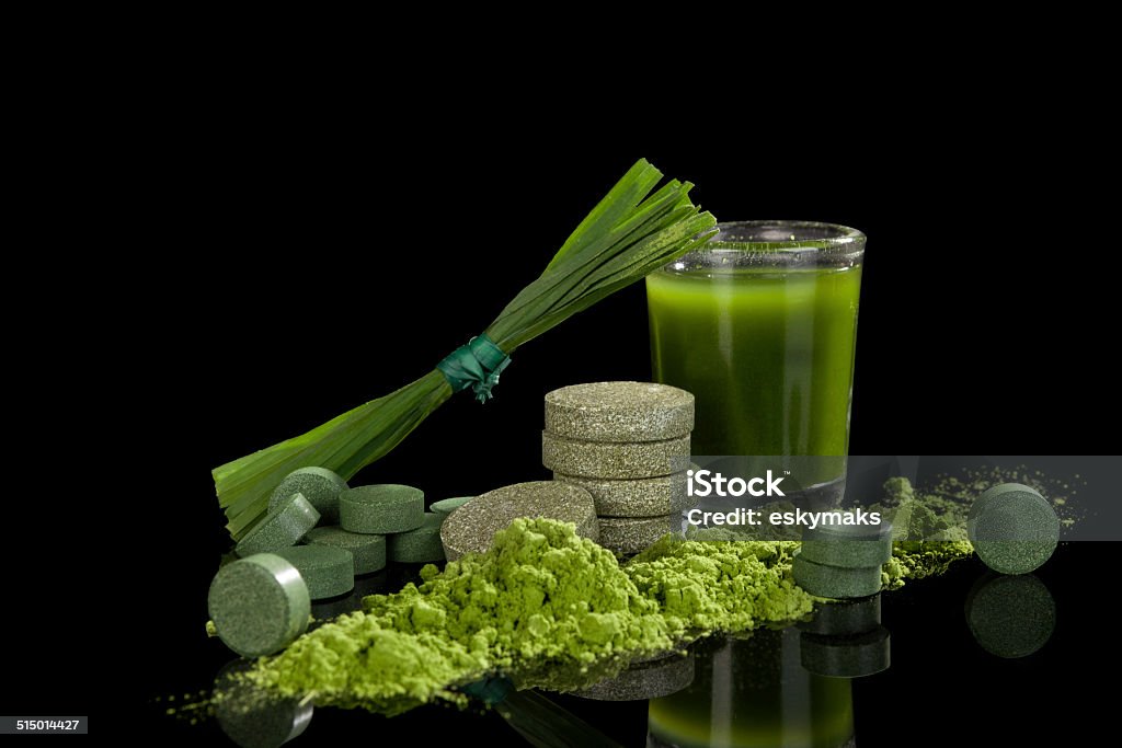 Alternative medicine. Alternative natural medicine. Green dietary supplements. Spirulina, chlorella and wheat grass isolated on black background. Green superfood, detox. Algae Stock Photo