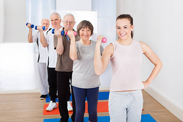 istock Trainer And Customers Exercising With Dumbbells 515014799