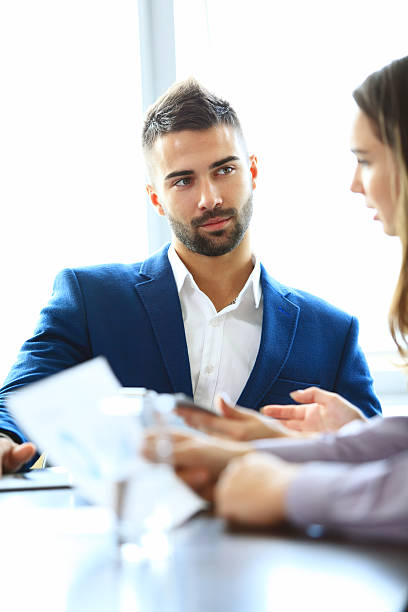 istock business partners discussing documents and ideas at meeting 515014955