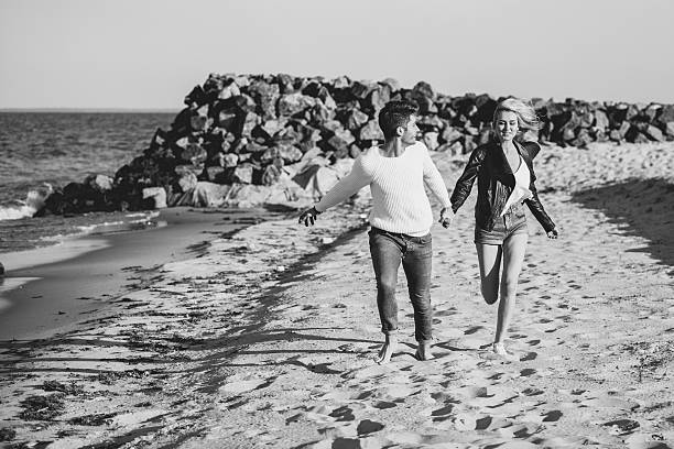 istock Couple playing on beach smiling 515047269