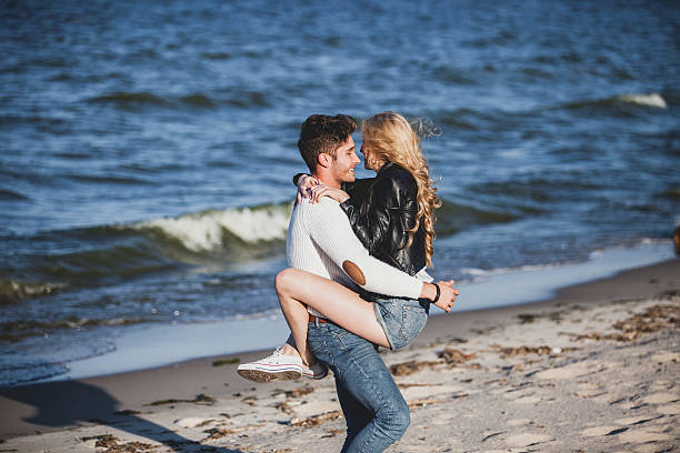 istock Couple playing on beach smiling 515047669