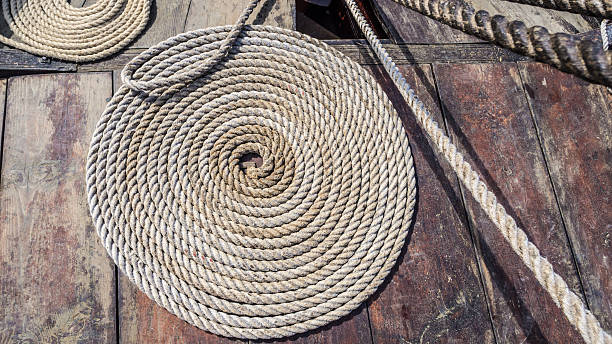 istock Curled up tarred hemp rope on viking ship deck 515054423