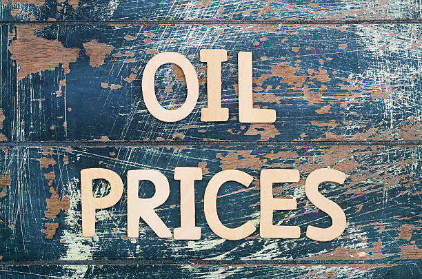 istock Oil prices written with wooden letters on rustic surface 515059988