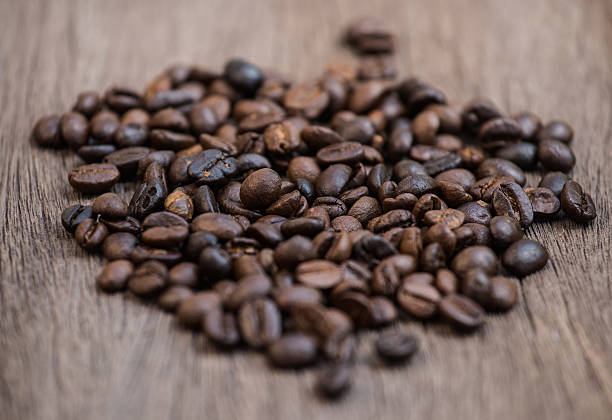 istock Coffee beans on the old wooden 515064208