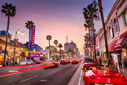 Los Angeles, USA - March 1, 2016: Traffic and pedestrians on Hollywood Boulevard at dusk. The theater district serves as a famous tourist attraction.