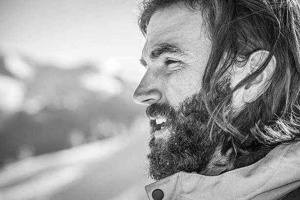 A monochromatic profile portrait of a young man, capturing his side profile with a timeless elegance and a touch of mystery.