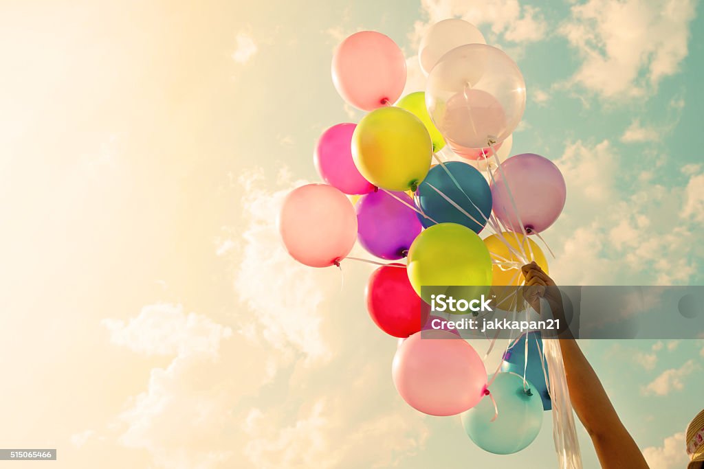 Colorful balloon Girl hand holding colorful balloons. happy birthday party. vintage filter effect Balloon Stock Photo