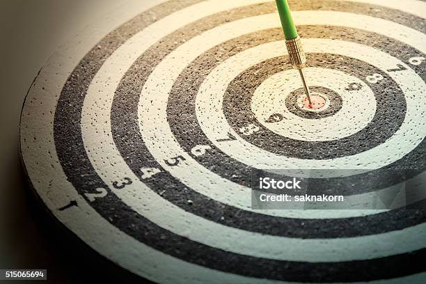 Dart Arrow Hitting In The Target Center Of Dartboard Stock Photo - Download Image Now