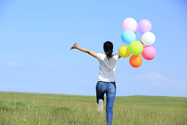 istock young asian woman  with colored balloons 515065805