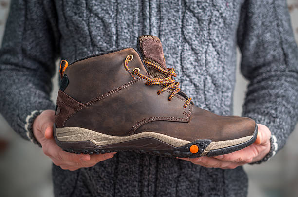 istock pair of brown shoes in hands 515065998