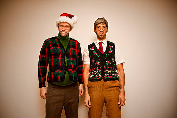 Nerdy Christmas Two nerds, wearing sweet sweaters, getting ready to party, Christmas style. christmas ugliness sweater nerd stock pictures, royalty-free photos & images