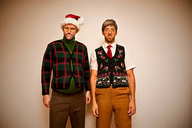 Two nerds, wearing sweet sweaters, getting ready to party, Christmas style.