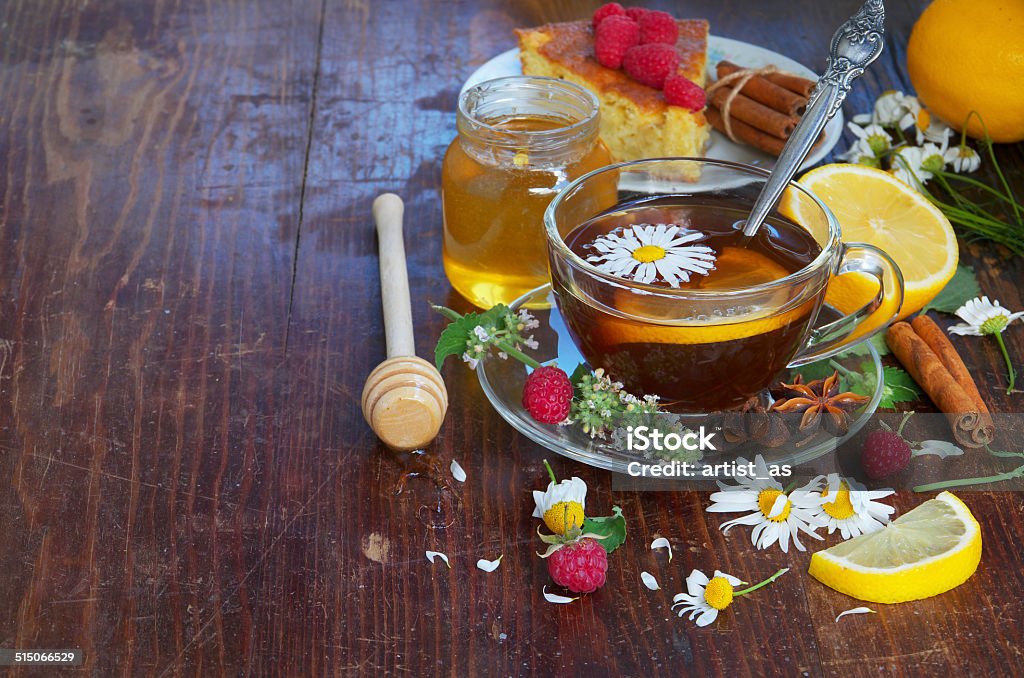 Herbal tea with chamomile flowers Herbal tea with chamomile flowers and Lemon. Berries and honey. Alternative Therapy Stock Photo