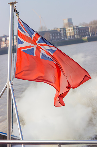 British flag flying in the wind on a boat.