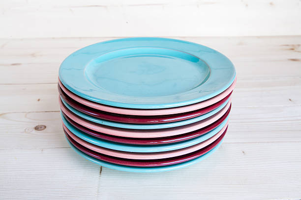 istock Colorful plates on a wooden background 515067437