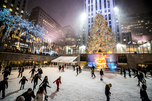 New York, USA  - January 2, 2014: People ice-skating at  Rockefeller Center at night , New York