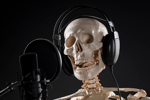 Skeleton singer, microphone, headphones