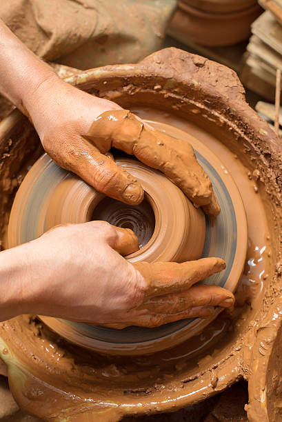 istock hands of a potter, creating an earthen jar 515069897