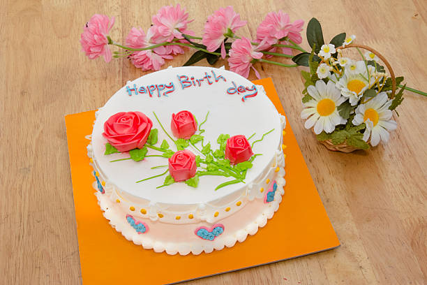 istock Cream cake with rose on the wooden table 515070611
