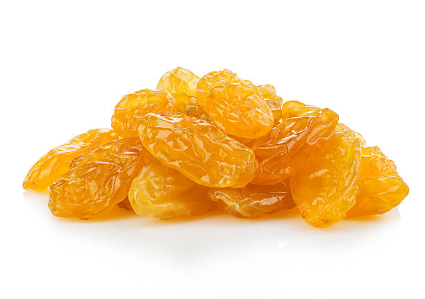 Yellow sultanas raisins close-up isolated on a white background. Yellow raisins close-up isolated on a white background. raisin stock pictures, royalty-free photos & images