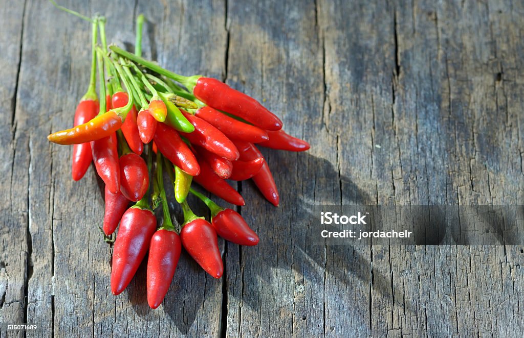 Chili pepper Chili pepper on old wood table Chili Pepper Stock Photo