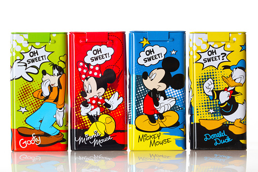 Marbach Germany - September 26, 2014: Set of four Disney figurines on cans filled with choco crunch, distributed by the company IFC Germany GmbH. Studio shot on white background. Re-usable tins.