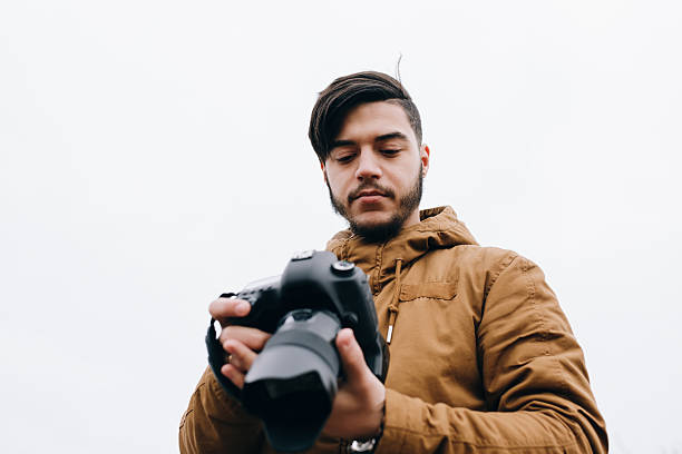 istock Photographer looking photo on his camera at open space 515071948
