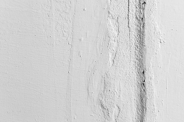 istock Vertical crack in white painted wall, closeup texture 515074996